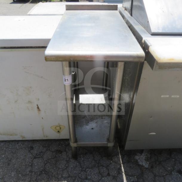 Stainless steel table with SS undershelf, dimensions 15"x30"x37". In used condition, marked with number 21.