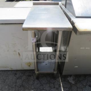 Stainless steel table with SS undershelf, dimensions 15"x30"x37". In used condition, marked with number 21.