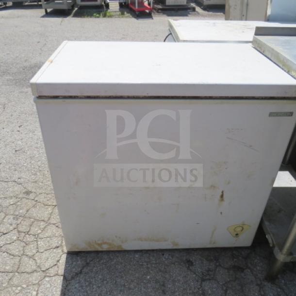 Thomson chest freezer, dimensions 35x22x33 inches, working condition, visible wear, exterior shows marks and discoloration.