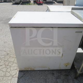 Thomson chest freezer, dimensions 35x22x33 inches, working condition, visible wear, exterior shows marks and discoloration.