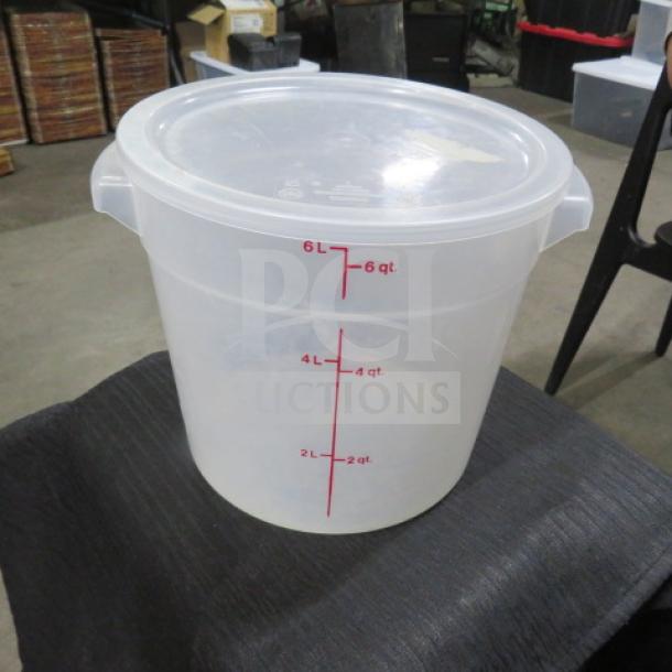 6-quart food storage container with lid, clear plastic, visible red measurement markings from 2 to 6 quarts.