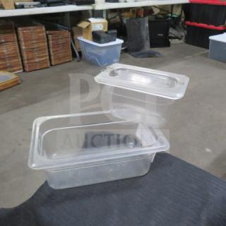 Assorted size clear food storage containers with lids, used condition, ideal for kitchen organization.