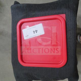 Red 6/8 quart food storage lid labeled "7XBID," in good condition, on a black cushion.