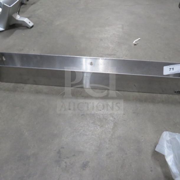 Krowne stainless steel bottle rail, 36x4.5x4.5 inches, mounted on ground. Shows minor wear, label with number "71".