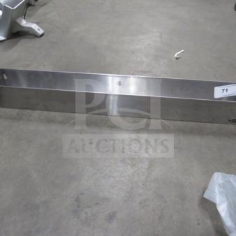 Krowne stainless steel bottle rail, 36x4.5x4.5 inches, mounted on ground. Shows minor wear, label with number "71".
