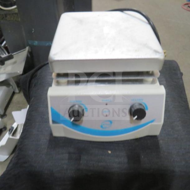 One Top Line Lab hot plate, white, dual dials, used condition, power and heat settings visible.