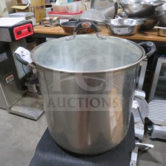 Stainless steel Tramontina 22-quart stock pot with lid, featuring sturdy handles, in good condition for auction.