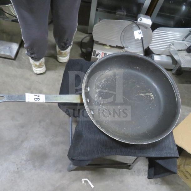 Superior 12-inch sauté pan with long handle, showing signs of use with visible surface scratches.