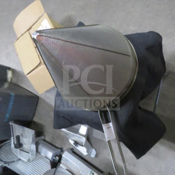 Stainless steel cone strainer with fine mesh, long handle, and sturdy construction, in excellent condition.