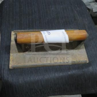 Steak weight with wooden handle, metal base; used condition; auction tag attached to handle.