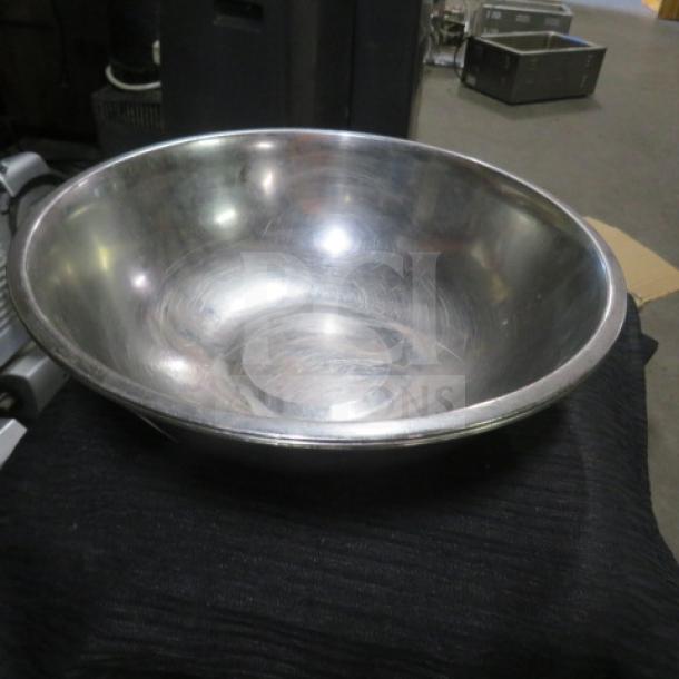 12-inch stainless steel mixing bowl, showing some wear. Model 3XBID. Ideal for kitchen use and durable.