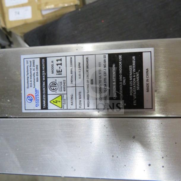 Eccotemp ie-11 tankless electric water heater, 240V, 11000W, stainless steel body, label with specs and safety info.