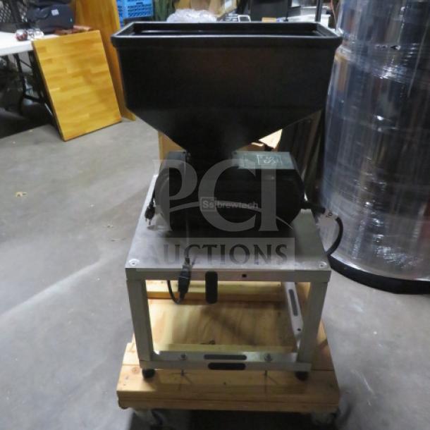 Ssbrewtech grain mill on a sturdy metal and wood base. Features a hopper for grain. Good condition, ideal for homebrewing.