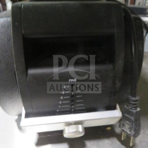 Electric adjustable blade sharpener with fine-tuning settings. Black casing, power cord attached. Used condition.