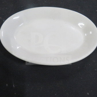 8.5x6 inch Tuxton oval plate, white ceramic, clean condition, model 12XBID. Ideal for serving, subtle elegant design.