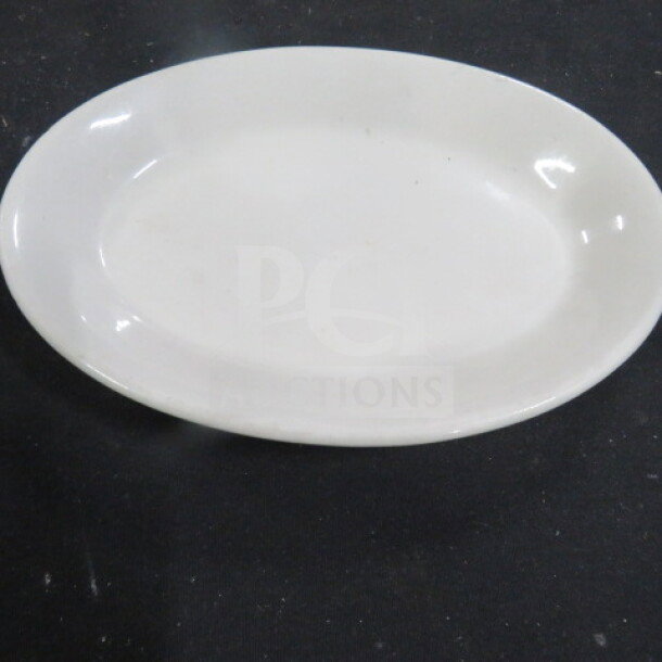 8.5x6 inch Tuxton oval plate, white ceramic, smooth finish, item 12XBID, in good condition.