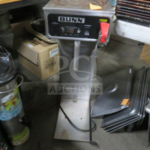Bunn tea brewer with filter basket, model 9x21x31. Stainless steel body, labeled controls, used condition.