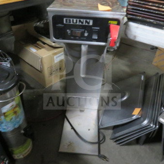 Bunn tea brewer with filter basket, model 9x21x31. Stainless steel body, labeled controls, used condition.