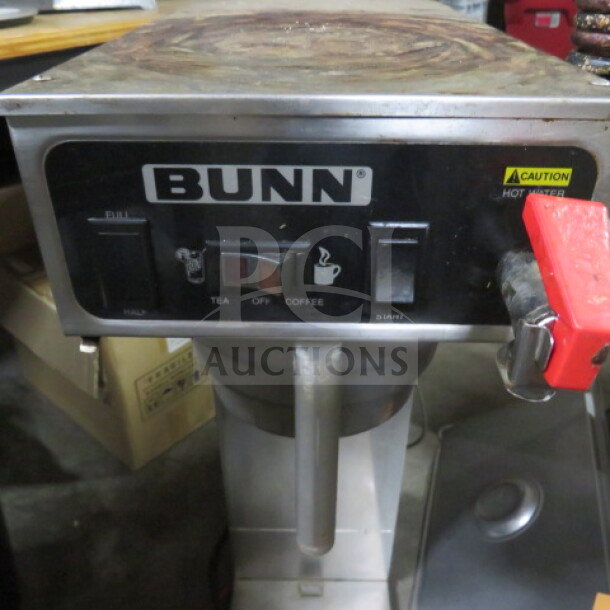 Bunn tea brewer with filter basket, 9x21x31 inches, visible control panel, used condition, caution hot water label.