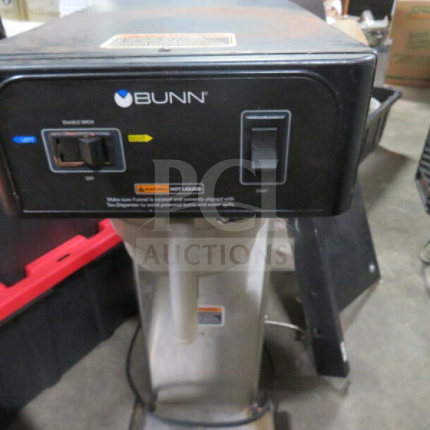 Bunn tea brewer with filter basket, 120V, dimensions 12.5x23x34.5 inches, features control switches and warning label.