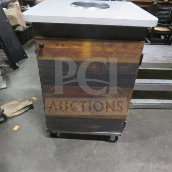 Wood-paneled trash receptacle on casters, 27x27x40, with a single door and metal top, used condition.