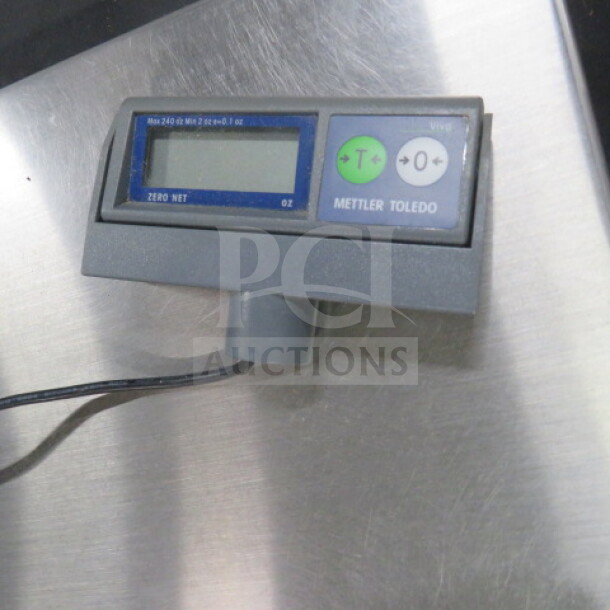Mettler Toledo scale, max 240oz capacity, digital display, gray casing, used condition.