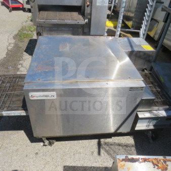Lincoln conveyor pizza oven on casters, 38x57x26.5 inches. Stainless steel, working condition when removed.