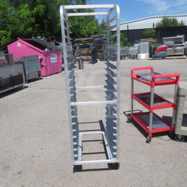 Aluminum speed rack on casters, 20.5x27x69 inches, used condition, ideal for storage and transport.