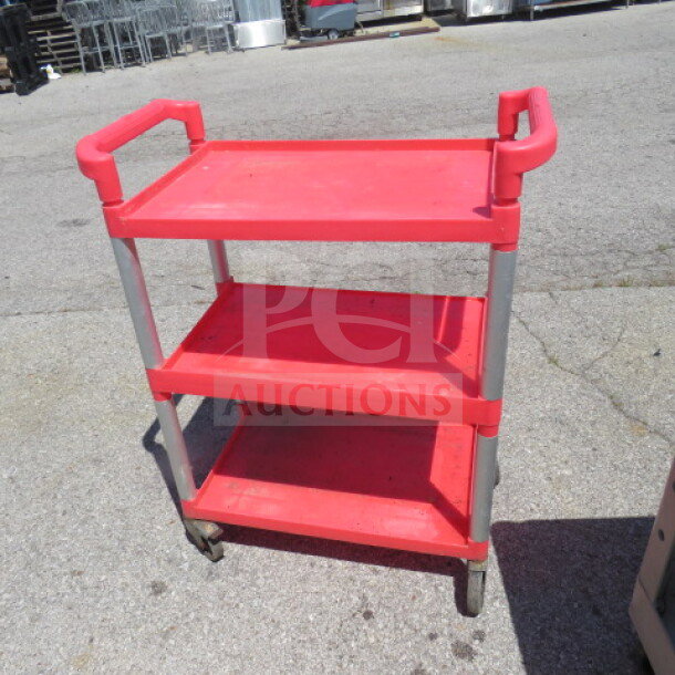 Red three-shelf poly cart on casters, measuring 32x16x39 inches. Sturdy construction with metal supports.