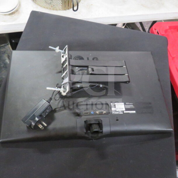 LG Flatscreen Monitor 23MP57HQ-P, showing rear view with stand and power adapter. Some wear visible on edges.