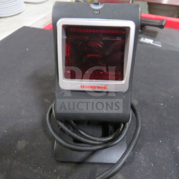 Honeywell 7580g scanner on stand, excellent condition, with visible branding. Features wired connectivity.