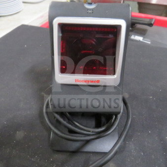 Honeywell 7580g scanner, black, with red scanning window, coiled cable, used condition, Honeywell logo on front.