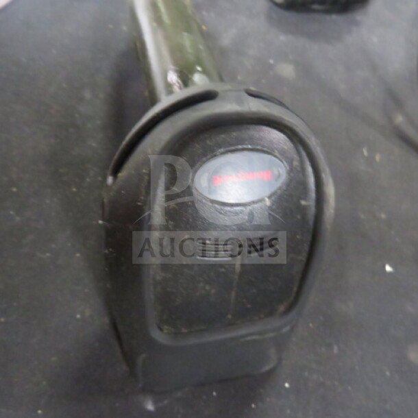 Honeywell handheld scanner, model 1900, in used condition, with visible Honeywell logo on the head.