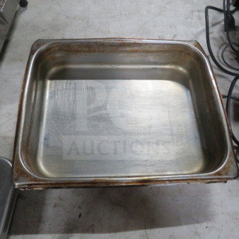 1/2 Size 2.5 Inch hotel pan, stainless steel, used condition with visible scratches and wear, model 2XBID.