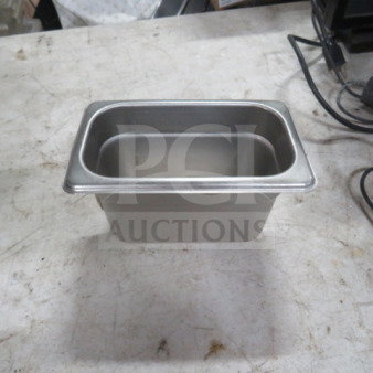 1/9 size 4-inch deep stainless steel hotel pan in excellent condition. Model 7XBID. Ideal for food service.