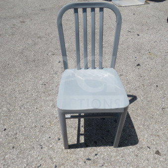 Silver metal indoor/outdoor chair, sturdy design, slatted back, in good condition, suitable for versatile use.