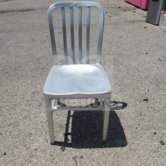 Silver aluminum indoor/outdoor chair, sturdy design, slatted back, suitable for versatile use, good condition.