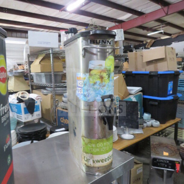 Bunn beverage dispenser with iced tea graphics, stainless steel body, and tap. Used condition.