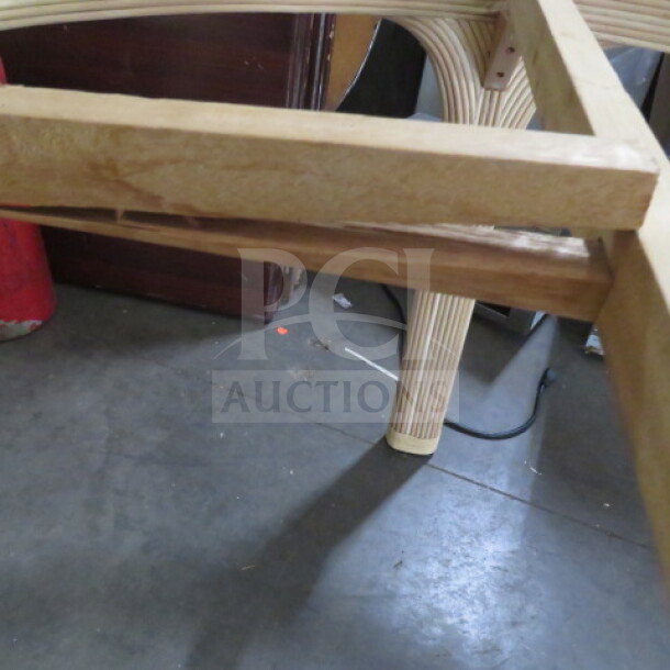 60-inch round rattan table, no glass top, cracked wood piece shown, new condition, intricate leg design.