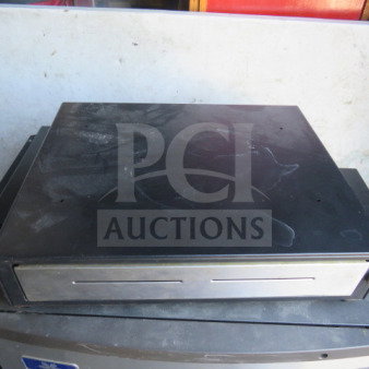 Partech T8115 cash drawer, black metal, front slot for checks, used condition with visible wear marks.