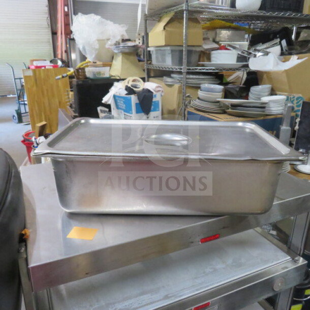 Full-size 6-inch deep stainless steel hotel pan with lid. Used condition. Ideal for commercial kitchen use.