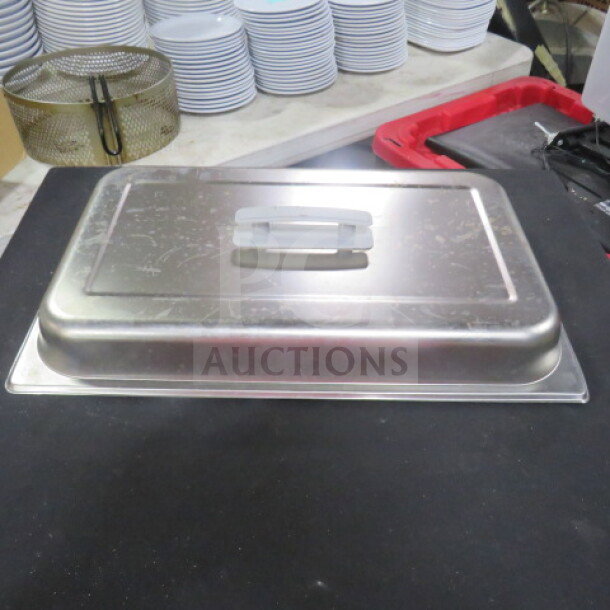 Full-size stainless steel chafer lid with handle, model 4XBID, in used condition. Visible scratches; ideal for catering.