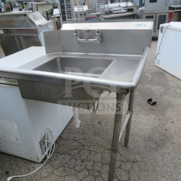 Regency stainless steel dirty side dishwasher table, 35.5x30 inches, features integrated sink, sturdy construction, used.