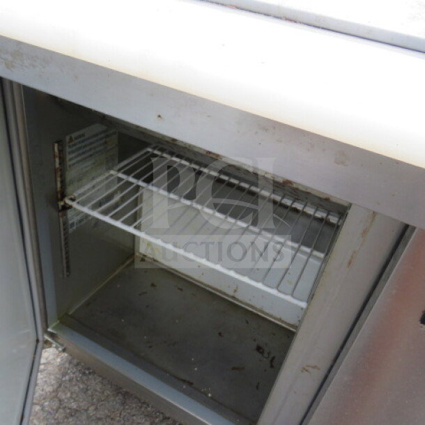 Avantco 2-door refrigerated prep table, model 178APT48MHC, with cutting board, on casters, includes 2 racks, 47x36x46 inches.