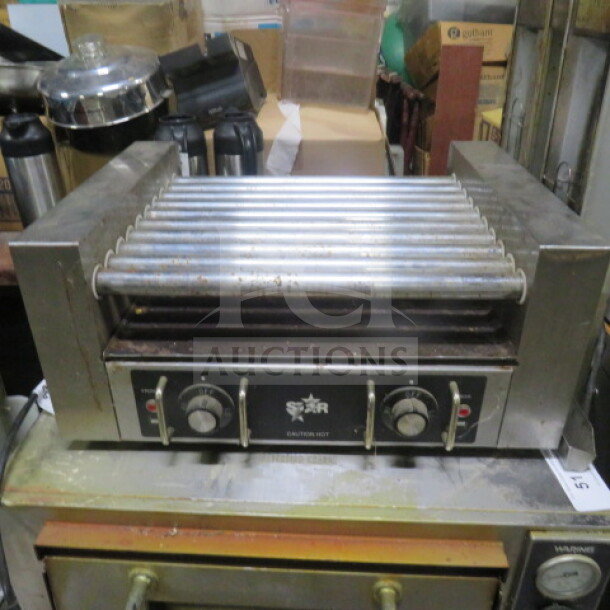 Star Hot Dog Roller, Model 25, 120 Volt, 23x17x10.5 inches. Features control knobs, Star branding. Used condition.
