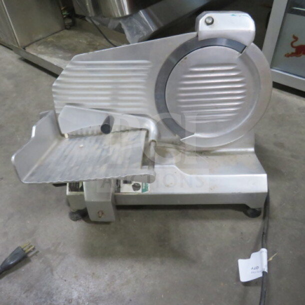 General food slicer, 120 Volt, stainless steel. Features ribbed blade guard and tray, used condition.
