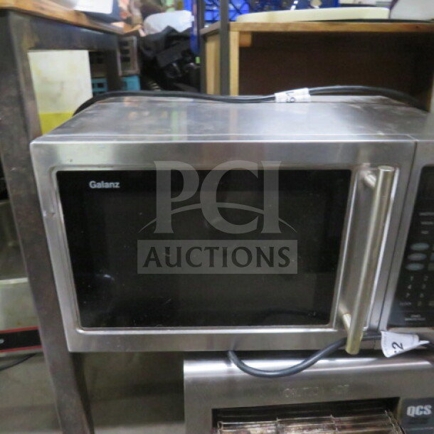 Galanz microwave, stainless steel, 120V, dimensions 20x13x12 inches. Front panel and handle visible.