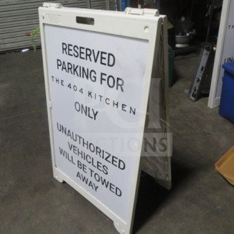 Signcade sidewalk sign, 26.5x42 inches. Displays "Reserved Parking for The 404 Kitchen Only." Used condition. Durable frame.