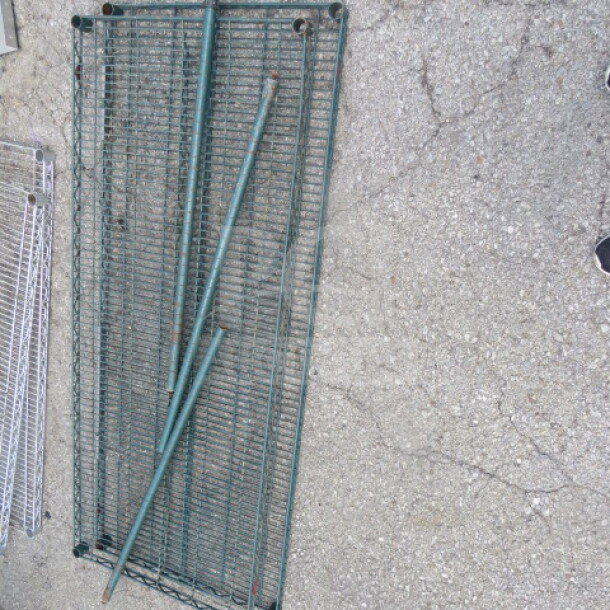 Metro shelving lot with two wire shelves and three poles, size 60x24 inches, metallic finish, used condition.