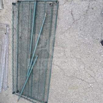 Metro shelving lot with two wire shelves and three poles, size 60x24 inches, metallic finish, used condition.